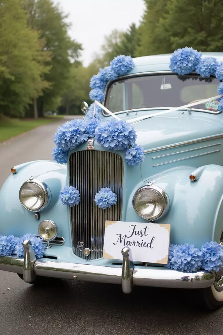Blue Hydrangea Decorated Getaway Car A professional photo, similar to a photo in a wedding magazine, of a vintage getaway car with blue hydrangea garlands and