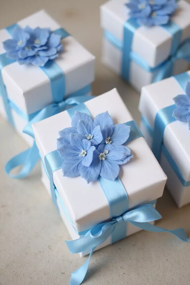 Hydrangea Themed Wedding Favors A professional photo, similar to a photo in a wedding magazine, of wedding favor boxes with pressed blue hydrangea designs and satin ribbons.