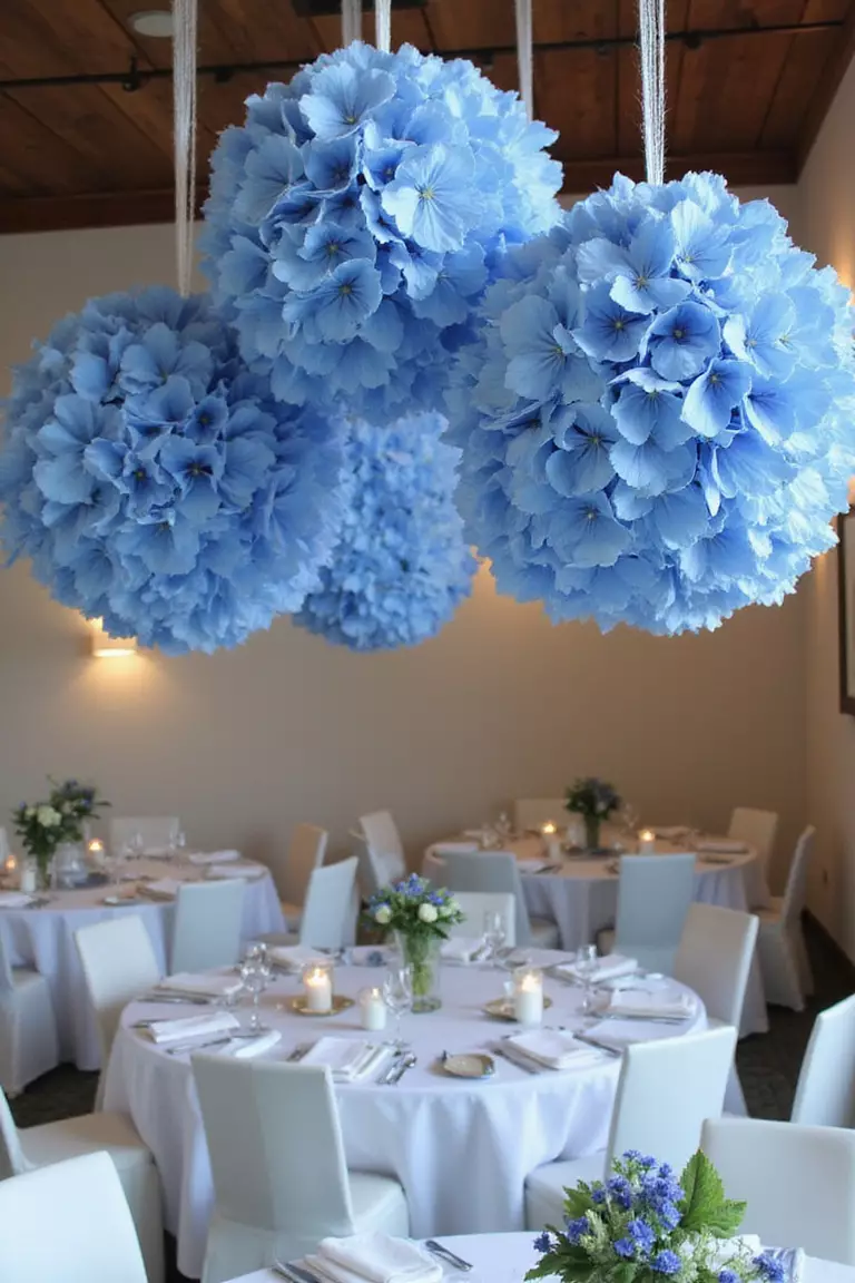 Hanging Hydrangea Ball Decorations A professional photo, similar to a photo in a wedding magazine, of spherical blue hydrangea balls hanging from transparent fishing line above reception tables.