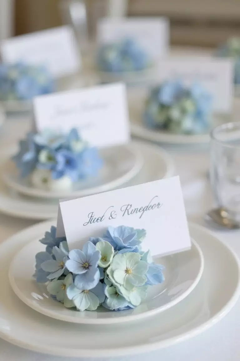 Hydrangea Place Card Holders A professional photo, similar to a photo in a wedding magazine, of delicate place card holders made from single blue hydrangea blooms holding name cards.