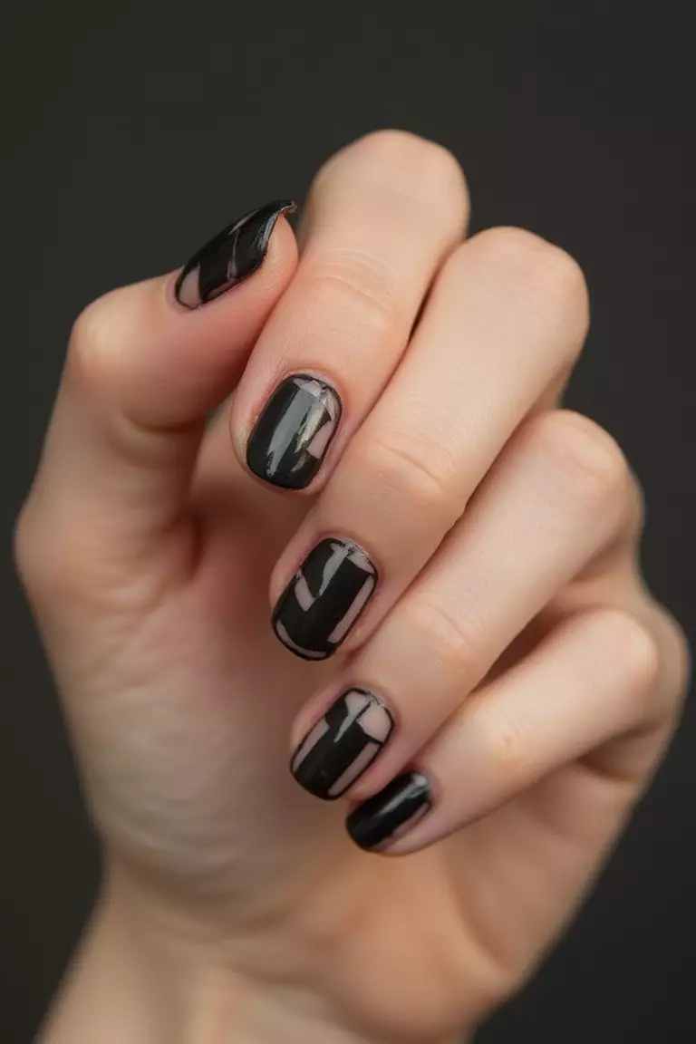 Negative Space Designs Close-up of a woman's hand with five fingers featuring black geometric patterns with clear negative space, creating modern minimalist nail art.