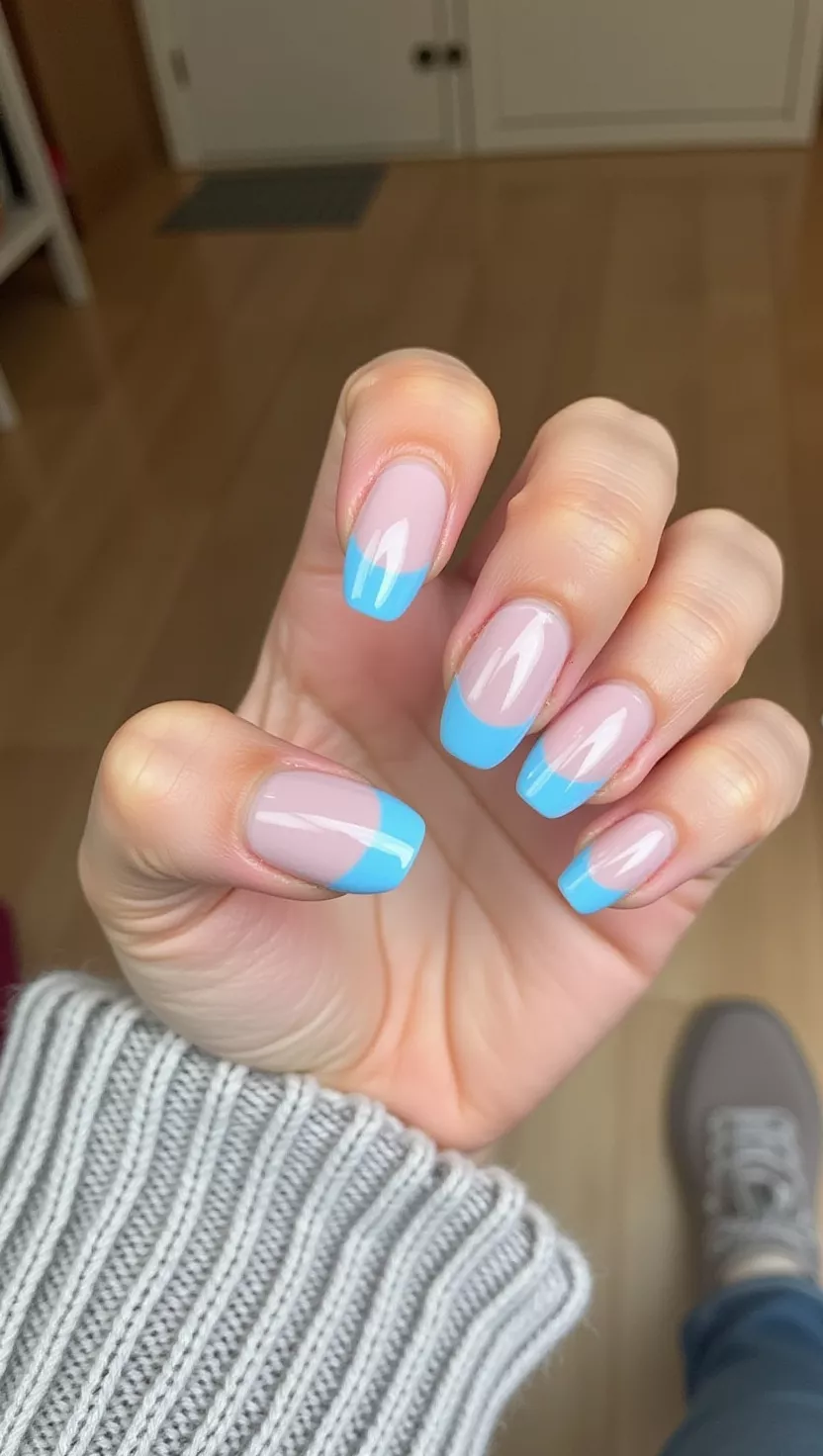 Icy Chrome Blue Tips close-up photo of a woman’s hand with five fingers showing nails with light icy blue chrome French tips on almond-shaped nails, room background
