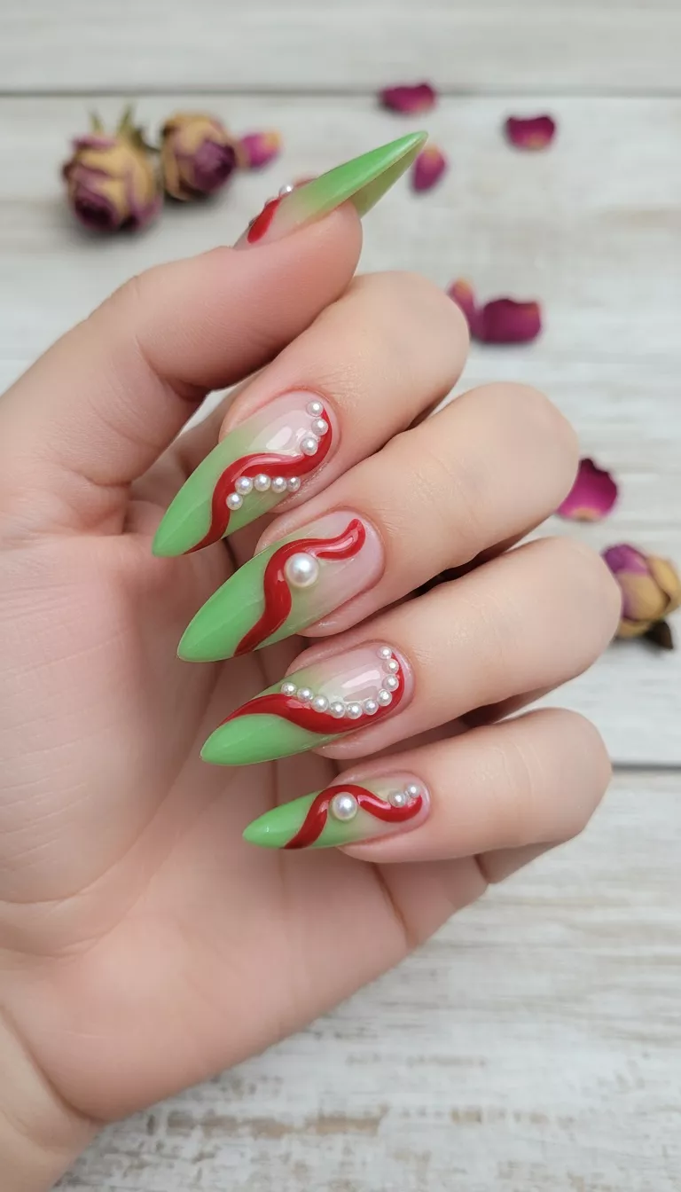 close-up shot of a woman’s hand showing nails with long and pointed nails featuring a clear base with green tips and a ribbon-like red design with pearl accents, close-up nail photography, nail polish designs, pinterest aesthetic