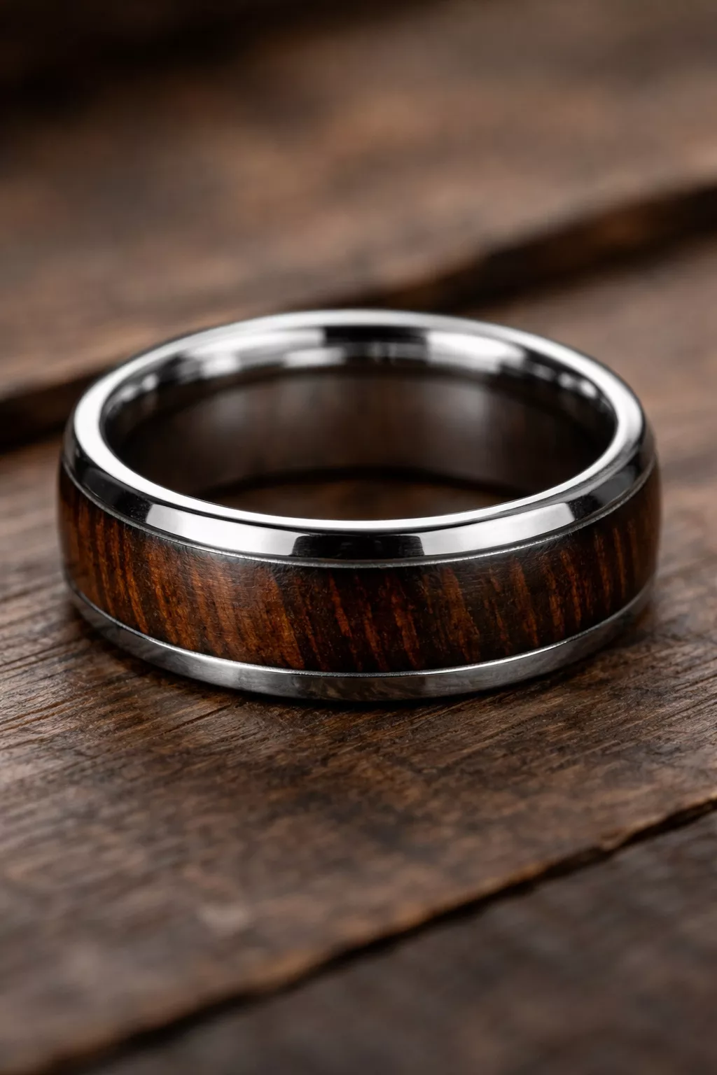 A realistic photo of a dark wood inlay wedding band with a polished silver titanium edge.