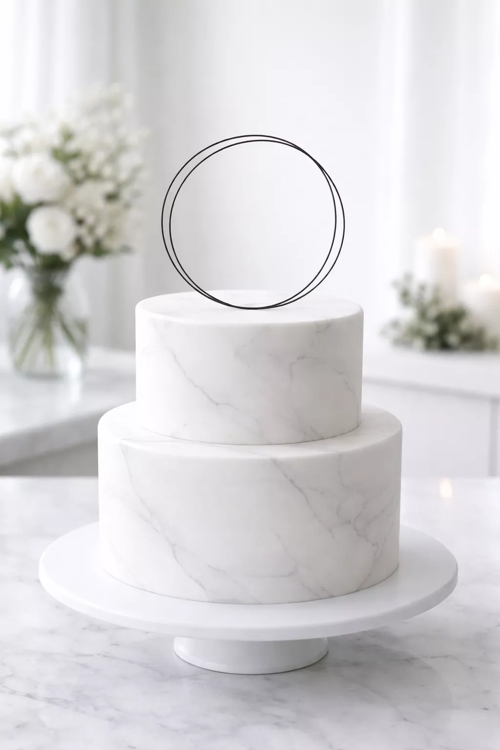 Minimalist Marble Cake A realistic photo of a small two-tiered white cake with very faint marble veining in light gray, topped with a single thin black wire topper, in a bright modern space.