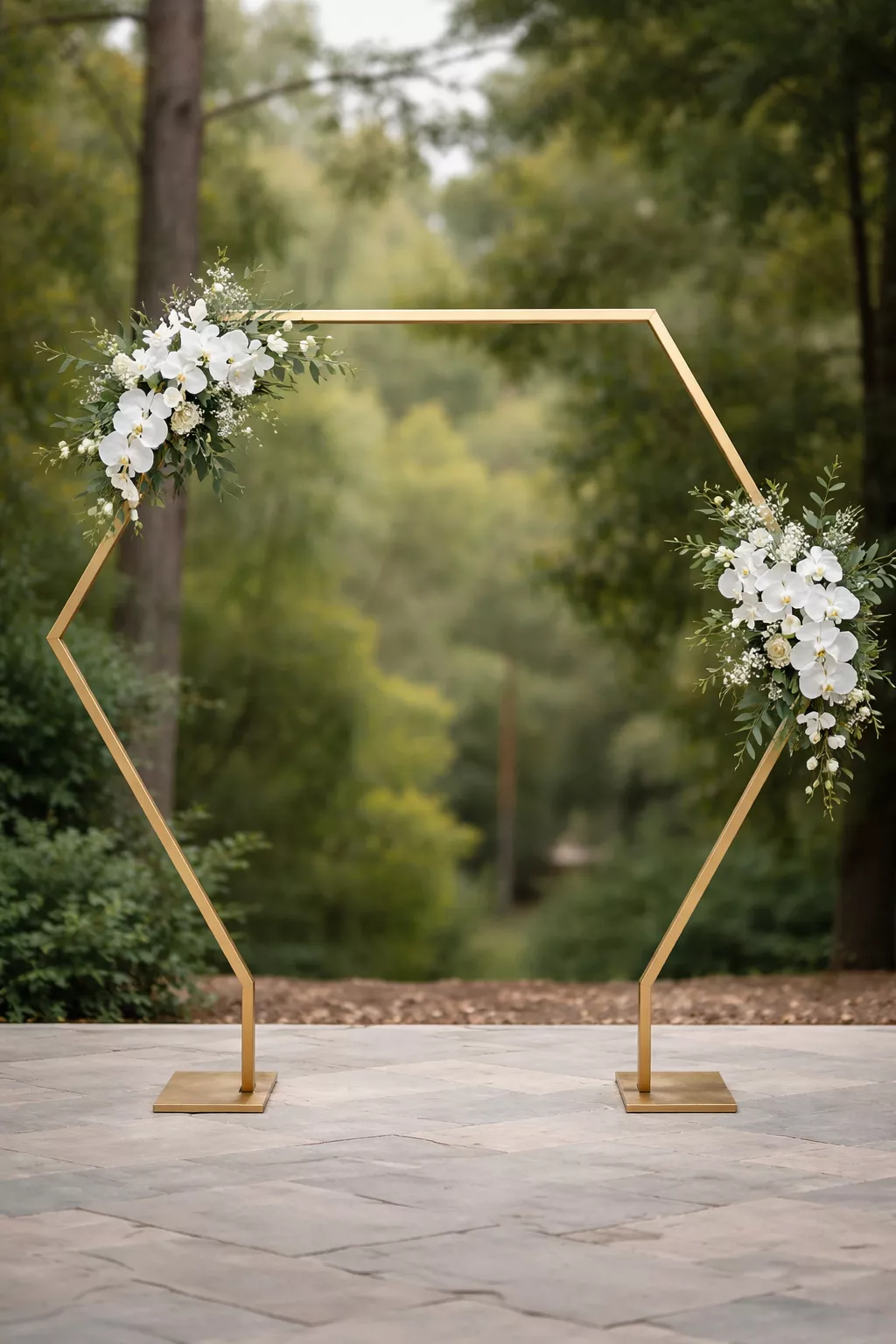 A realistic photo of a gold hexagonal metal wedding arch with white orchids and minimalist green leaves attached to the corners.