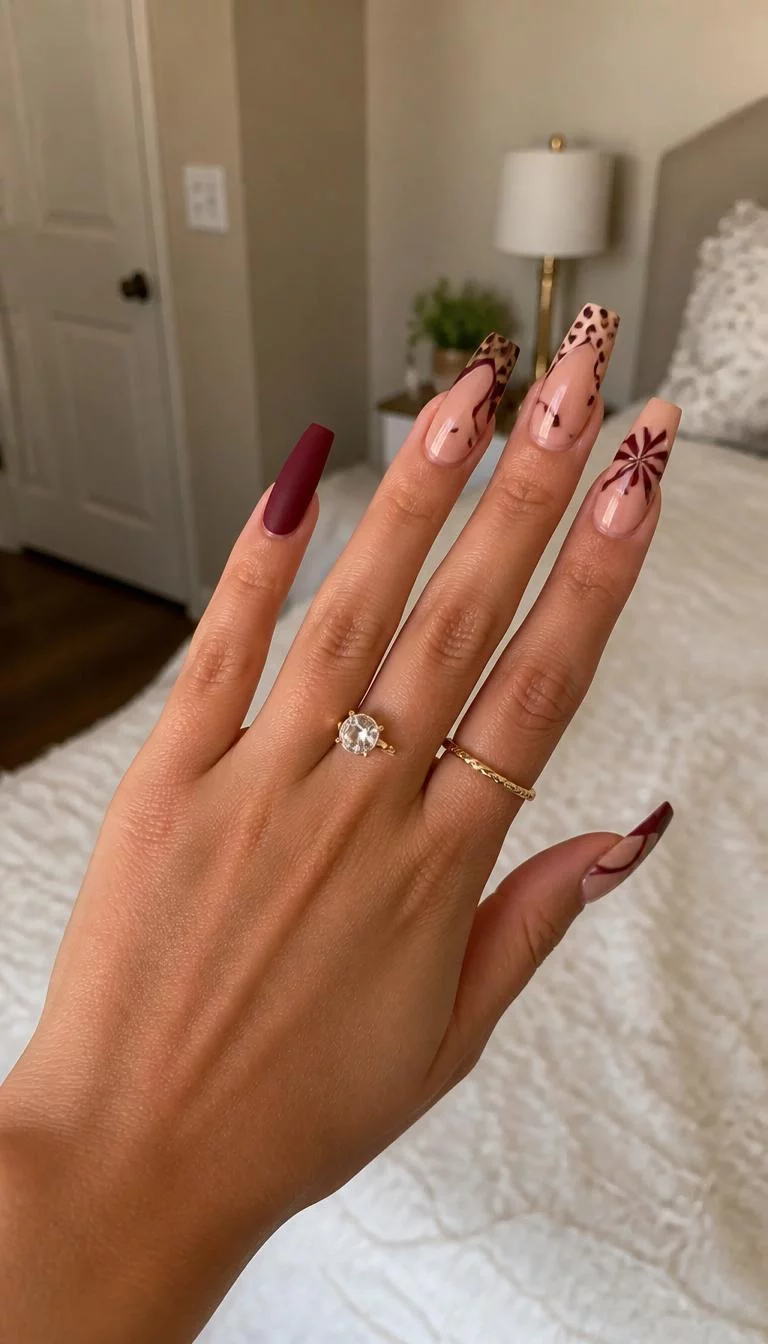 A photorealistic close-up shot of a woman's olive skin tone hand with five fingers, showcasing stiletto nails with animal prints and floral accents, abstract wavy French tips, and matte dark red coffin-shaped nails, bedroom background