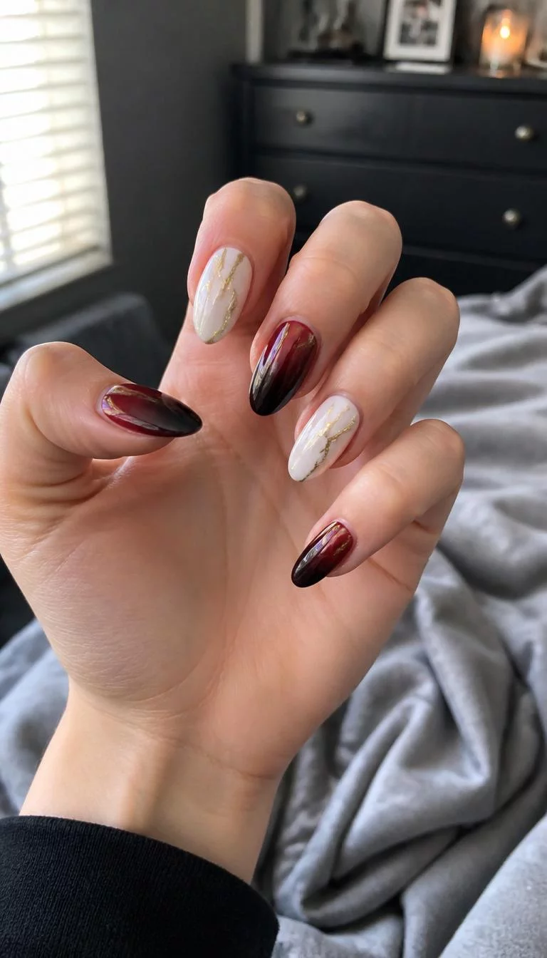 Gold Streaks And Ombre A photorealistic close-up shot of a woman's light skin tone hand with five fingers, showcasing almond shaped medium length nails featuring abstract gold streaks on an off-white base and ombre dark red to black, bedroom background
