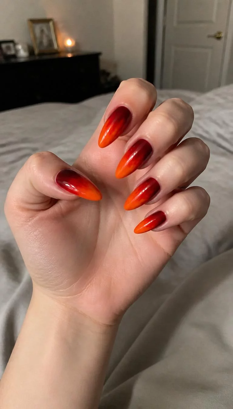 Fiery Stiletto Gradients A photorealistic close-up shot of a woman's light skin tone hand with five fingers, showcasing stiletto-shaped medium-long nails featuring a gradient design from deep red to orange, resembling fire, bedroom background