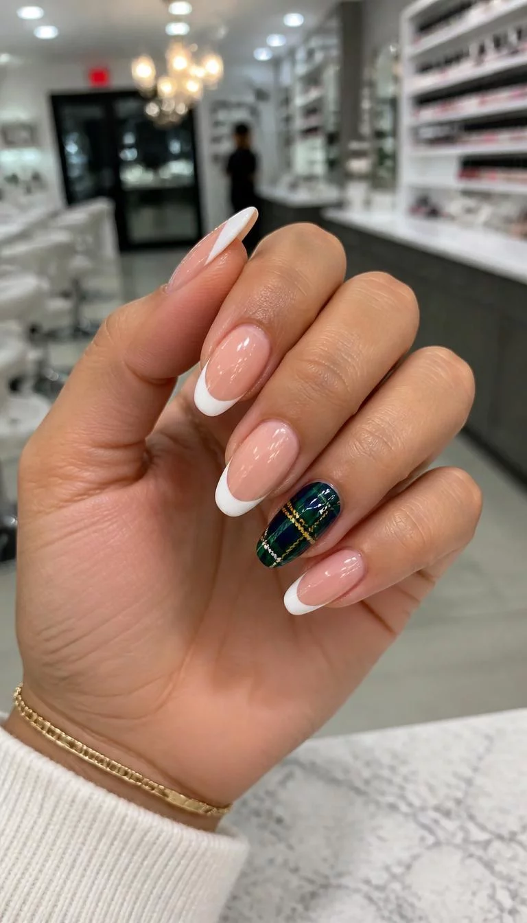 Emerald French Twist A photorealistic close-up shot of a woman's olive skin tone hand with five fingers, showcasing almond-shaped nails featuring a French tip design with a plaid accent nail in green and dark blue, nail salon background