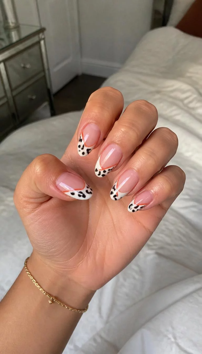 The Tiger Cowgirl Hybrid A photorealistic close-up shot of a woman's olive skin tone hand with five fingers, showcasing almond-shaped medium-length nails with a French tip and a cow print-inspired design featuring black spots, orange stripes, and a subtle pink base, bedroom background